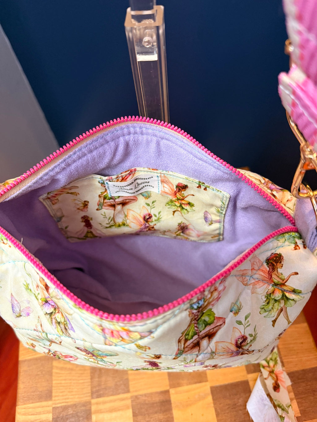 Interior of quilted crossbody showing purple suede liner