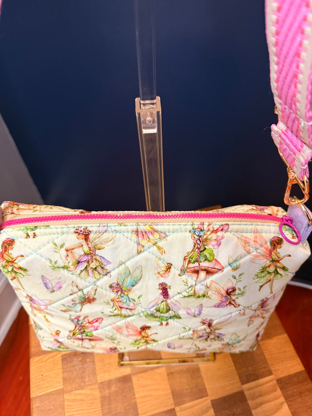 Close-up of quilted fairy print fabric and pink zipper