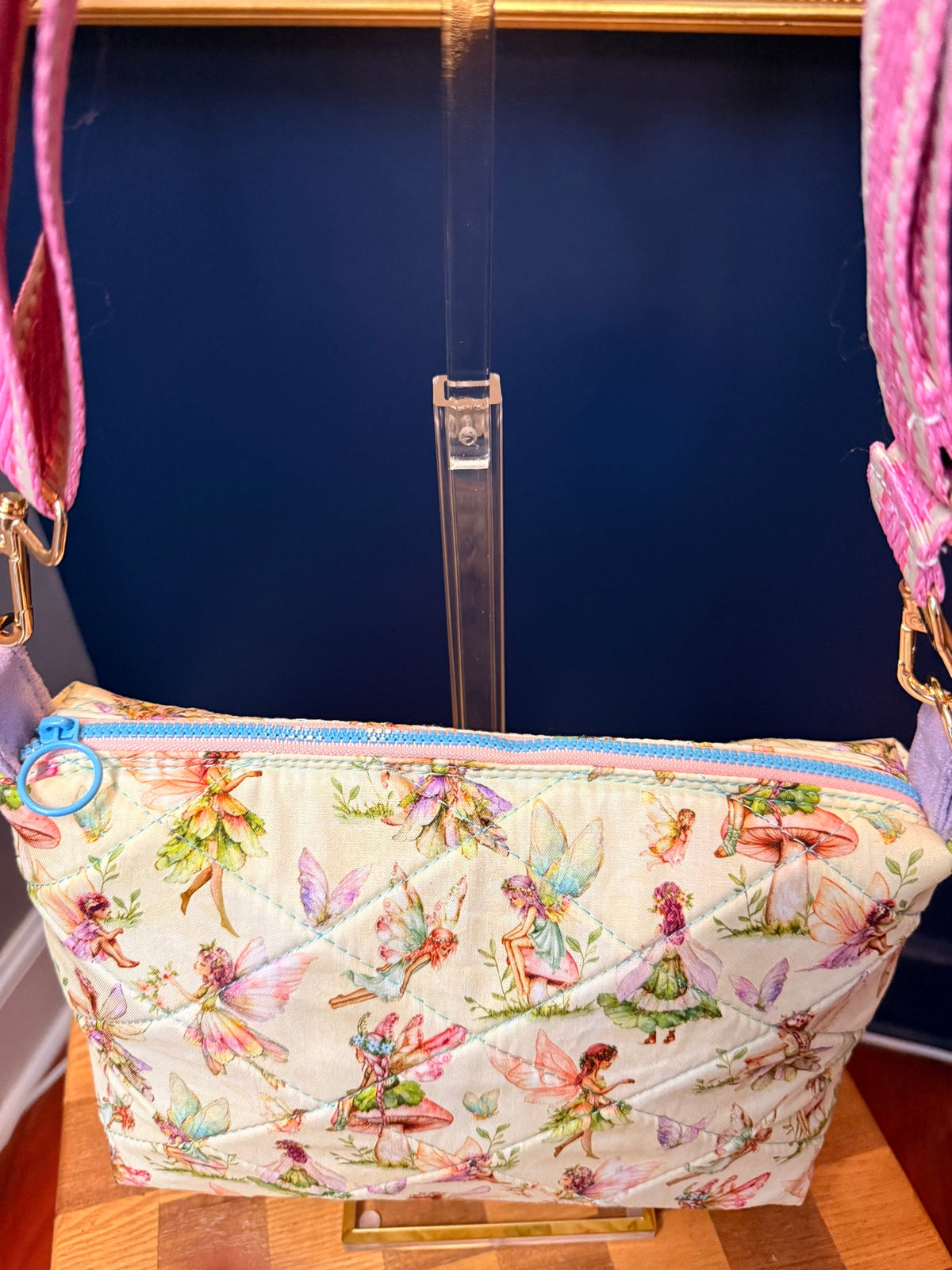 Close-up of blue zipper on quilted fairy print crossbody