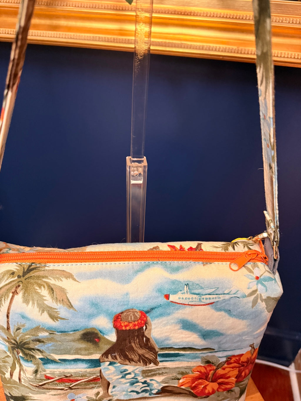 Close-up of orange zipper on vintage Hawaiian crossbody