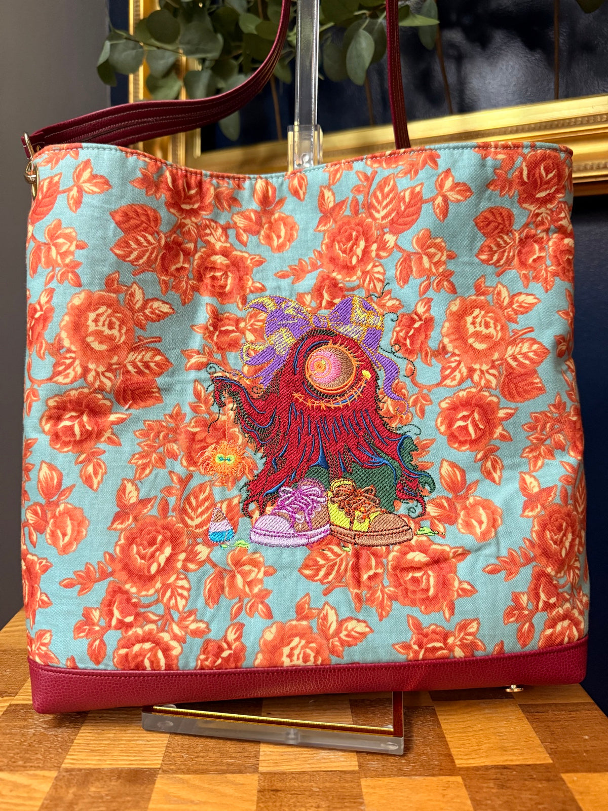 Front of tote with one-eyed monster embroidery