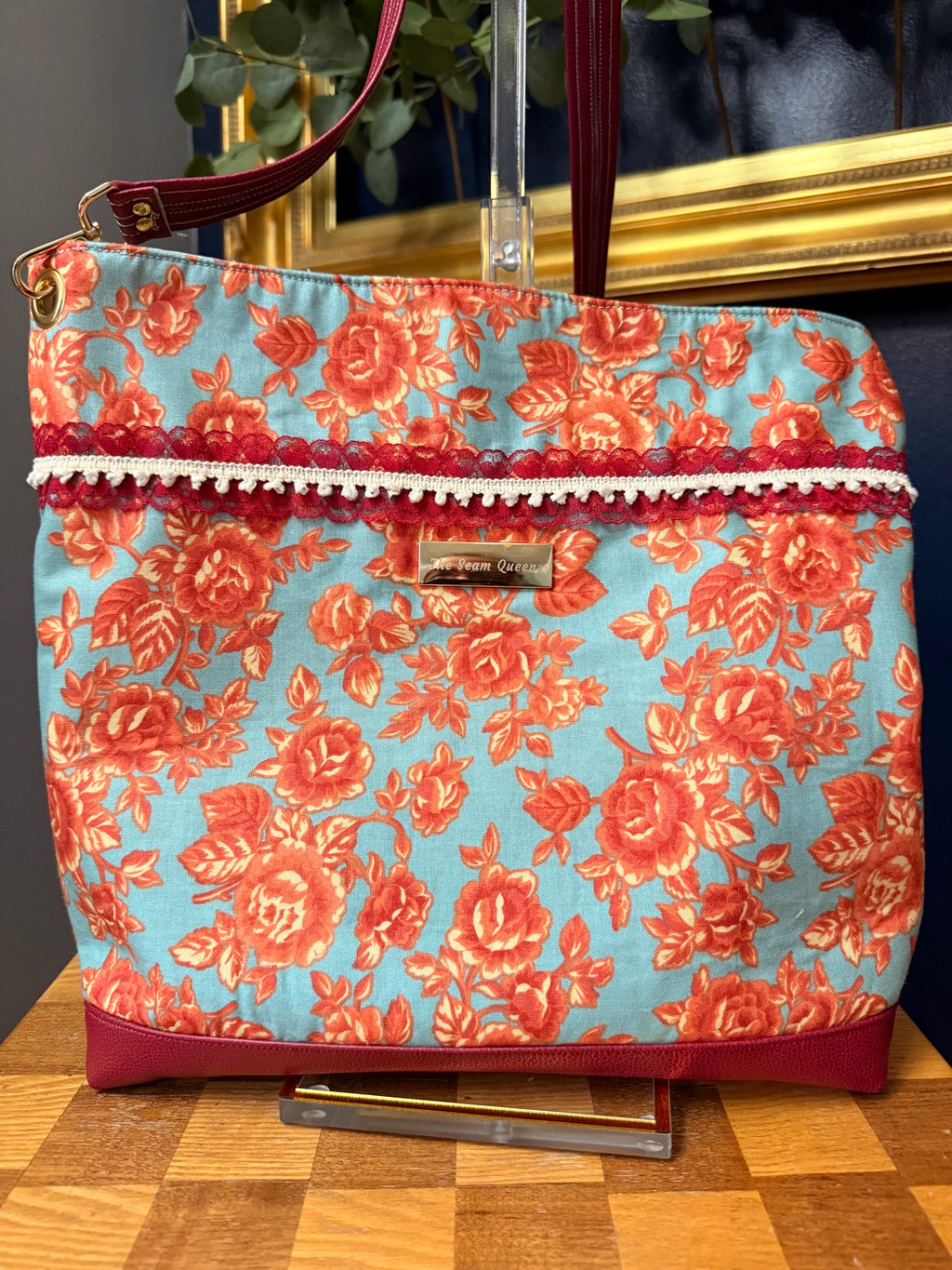 Back of the tote showing lace and pom trim detail