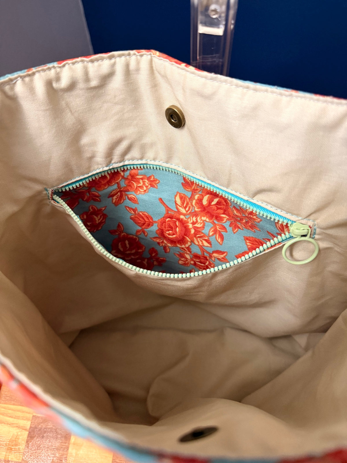 Interior zipper pocket open, lined in the floral rose print