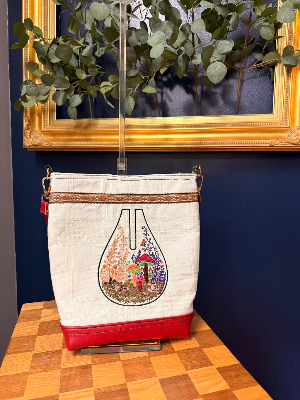 Tote with embroidered mushroom terrarium on upcycled tablecloth, front view