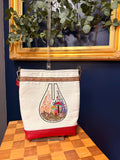 Tote with embroidered mushroom terrarium on upcycled tablecloth, front view
