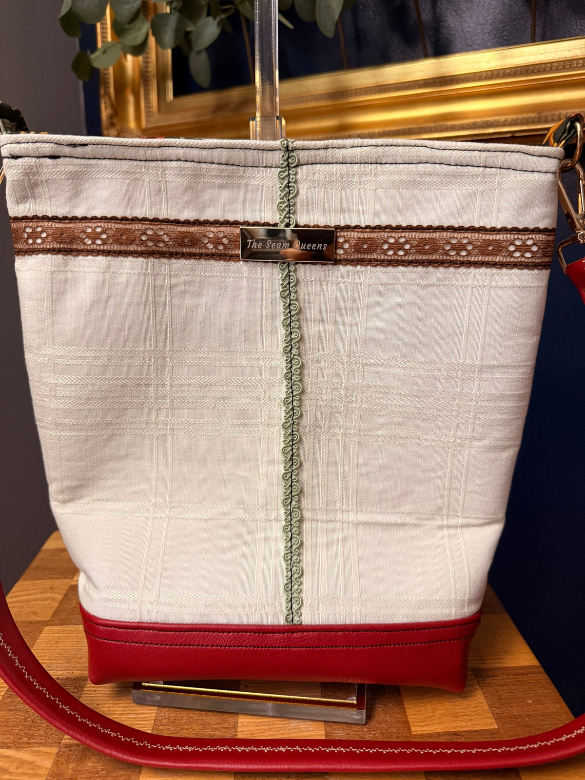 Back of tote with lace detail and The Seam Queens label