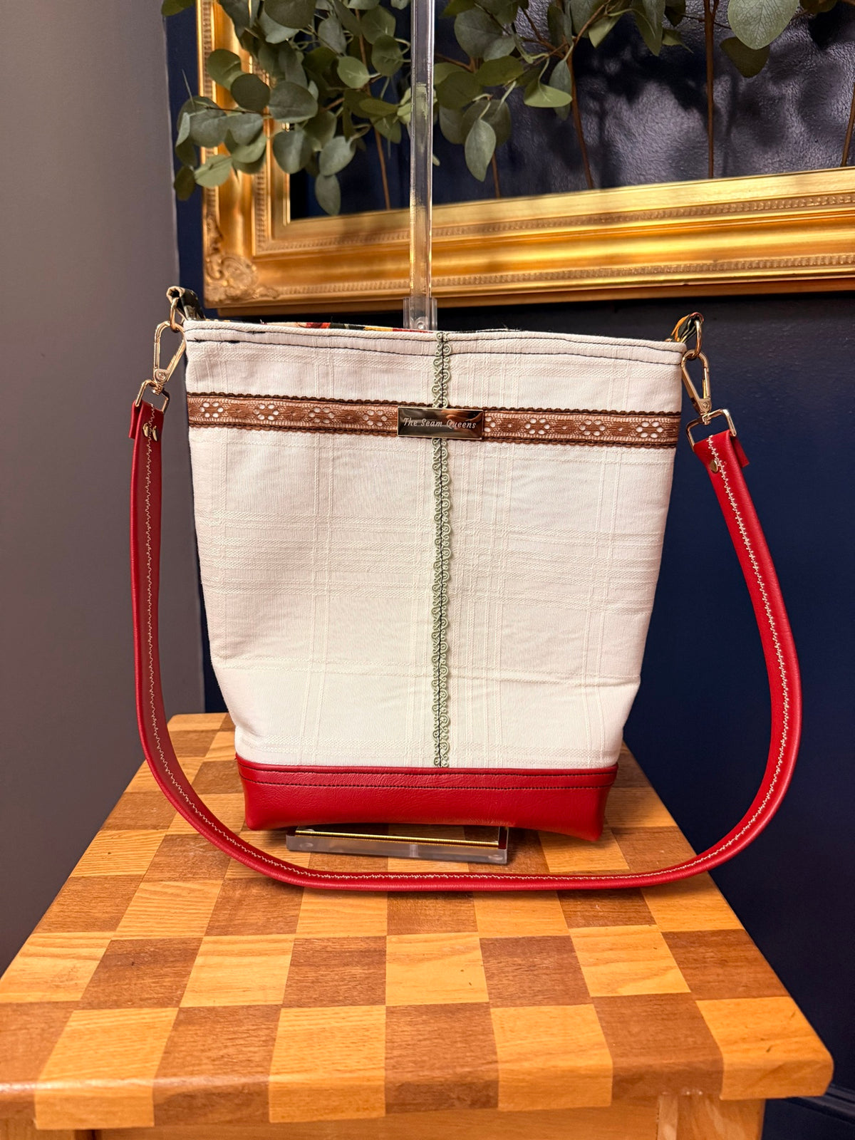 Back of the tote with red vinyl strap attached