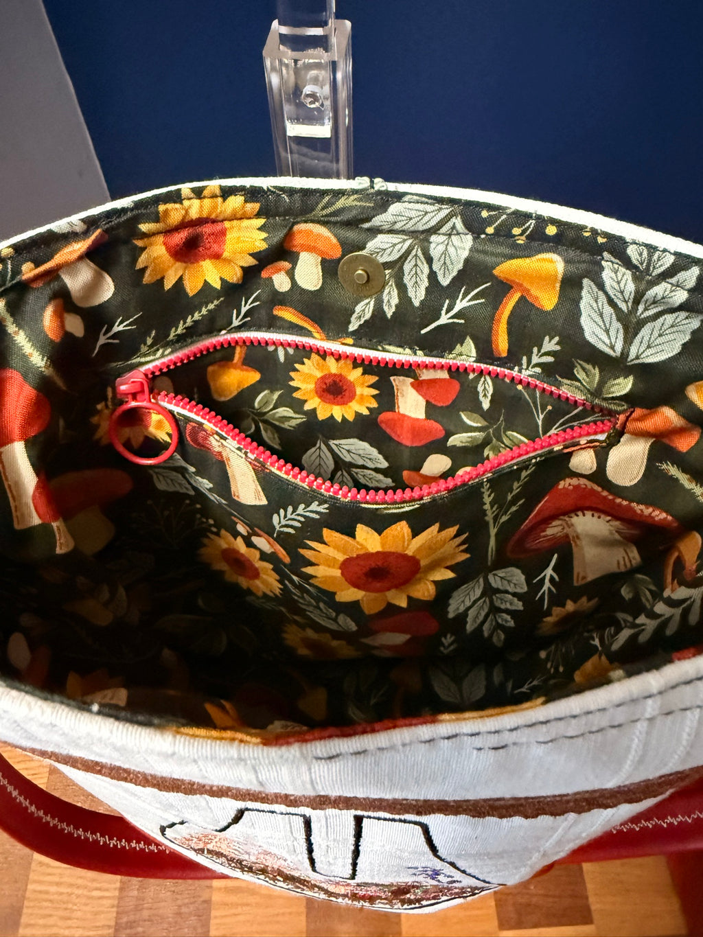 Interior zipper pocket open in matching mushroom print
