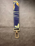 Keychain wristlet in navy fabric with gold floral print and gold hardware