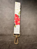 Keychain wristlet in white fabric with red garden flowers and gold hardware
