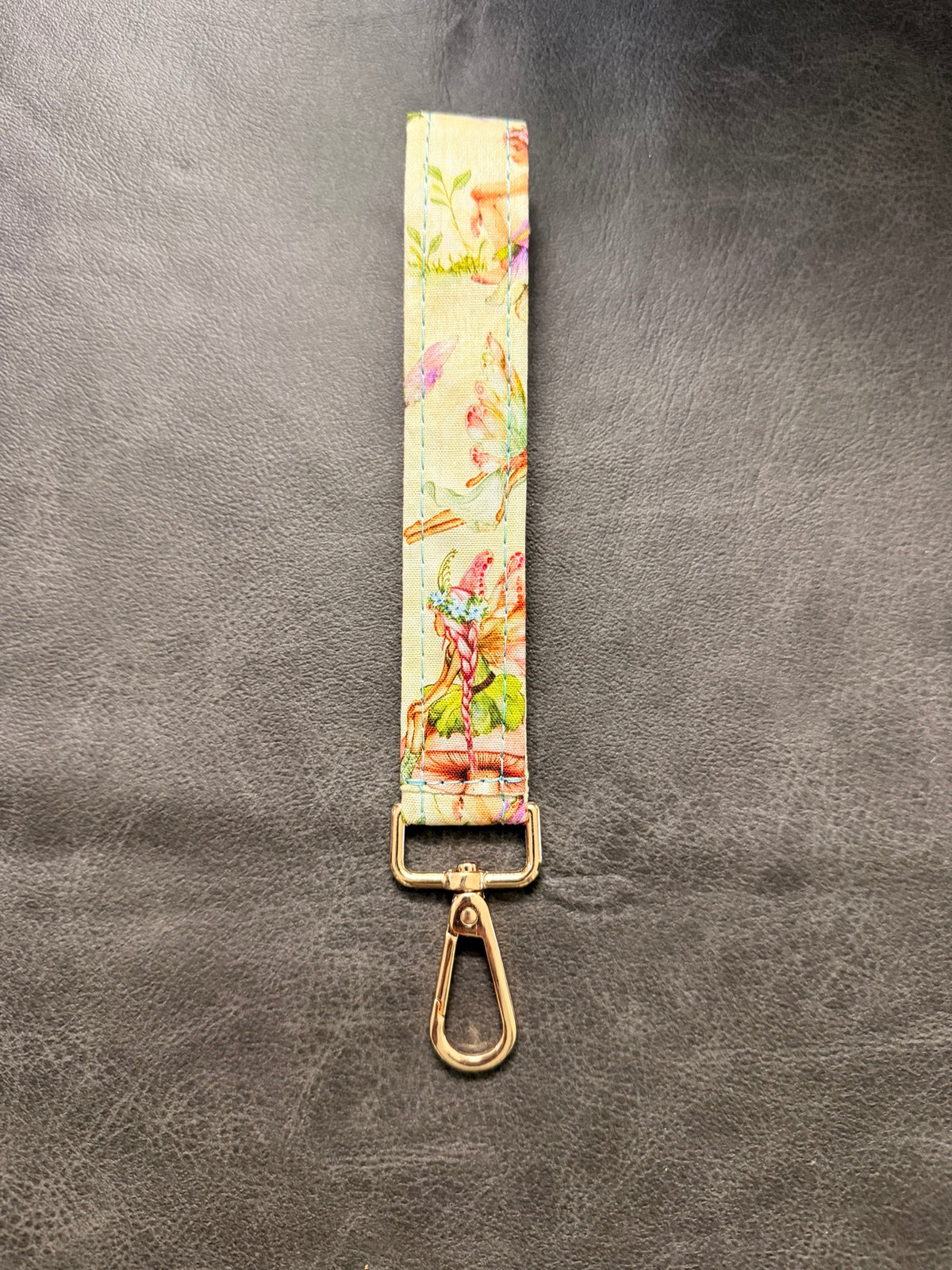 Keychain wristlet in cream fairy-illustration fabric with gold hardware